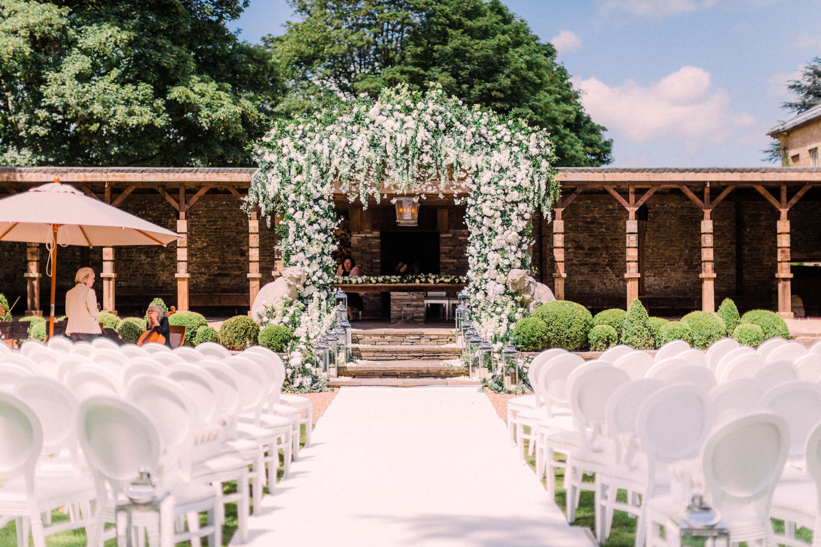 An outdoor ceremony flower arch by Amie Bone at Aynhoe Park