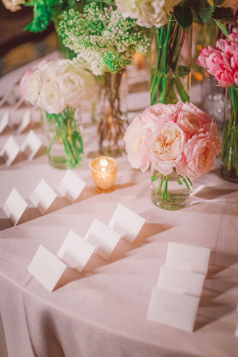 escort table names arranged neatly on a floral decorated table in Claridges