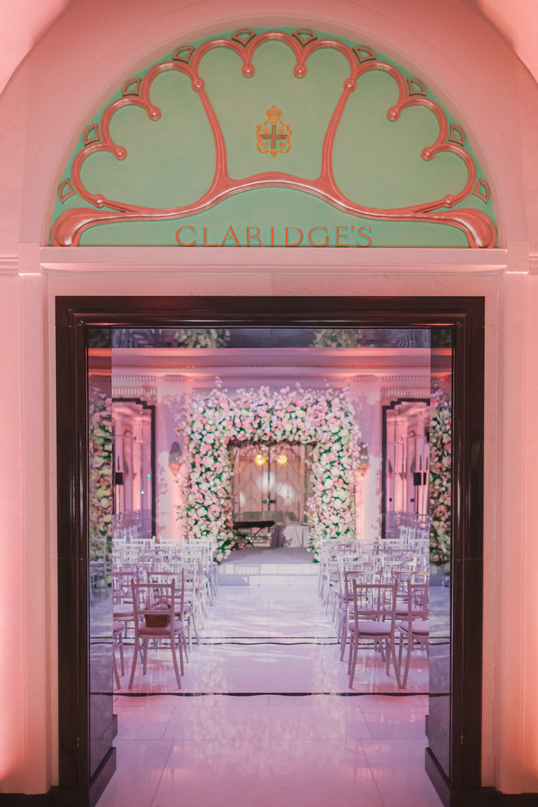 doorway entrance inside Claridge's Hotel to a wedding setting with floral chuppah