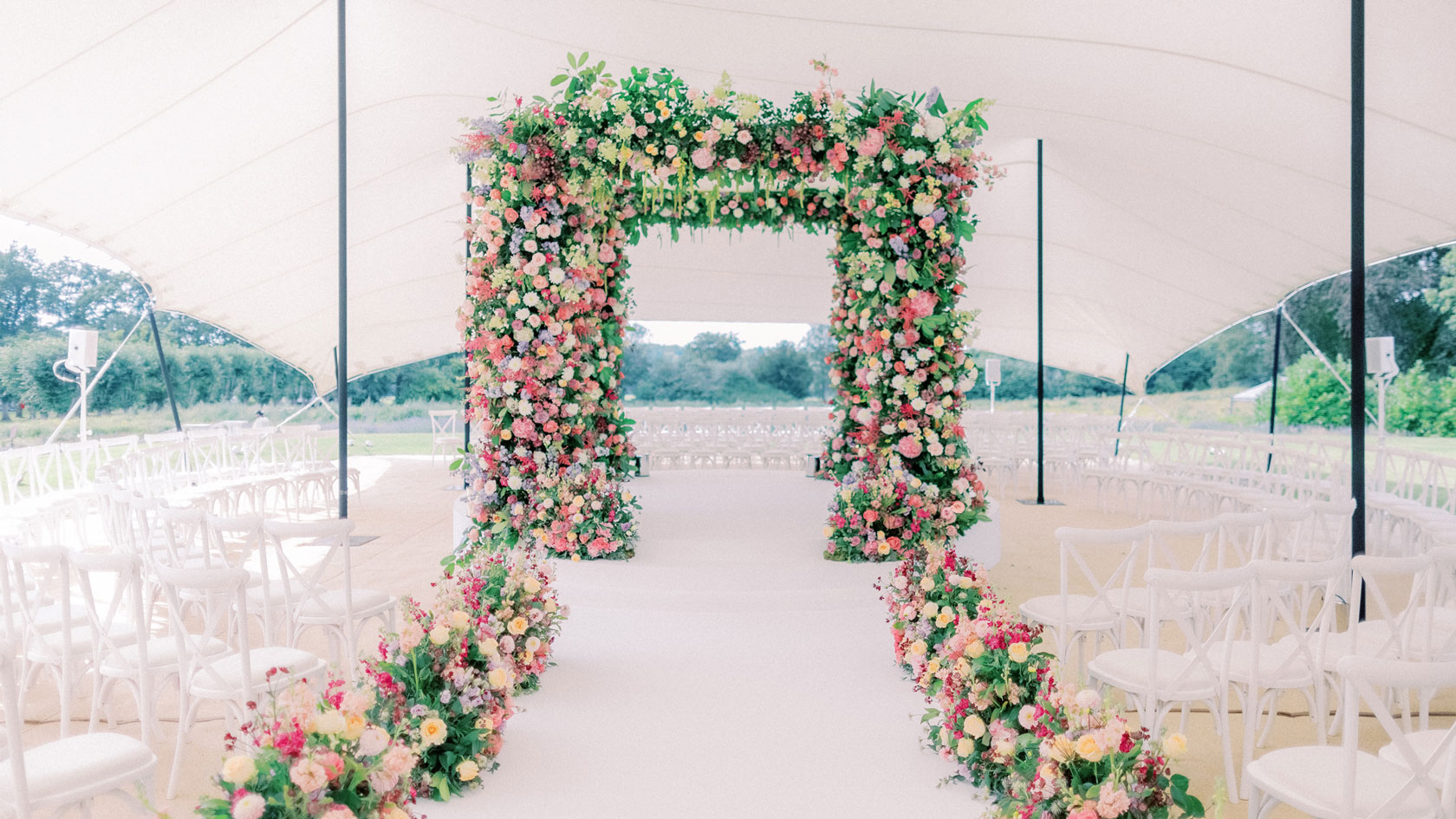 A chuppah made of flowers for a marquee wedding at Coworth Park